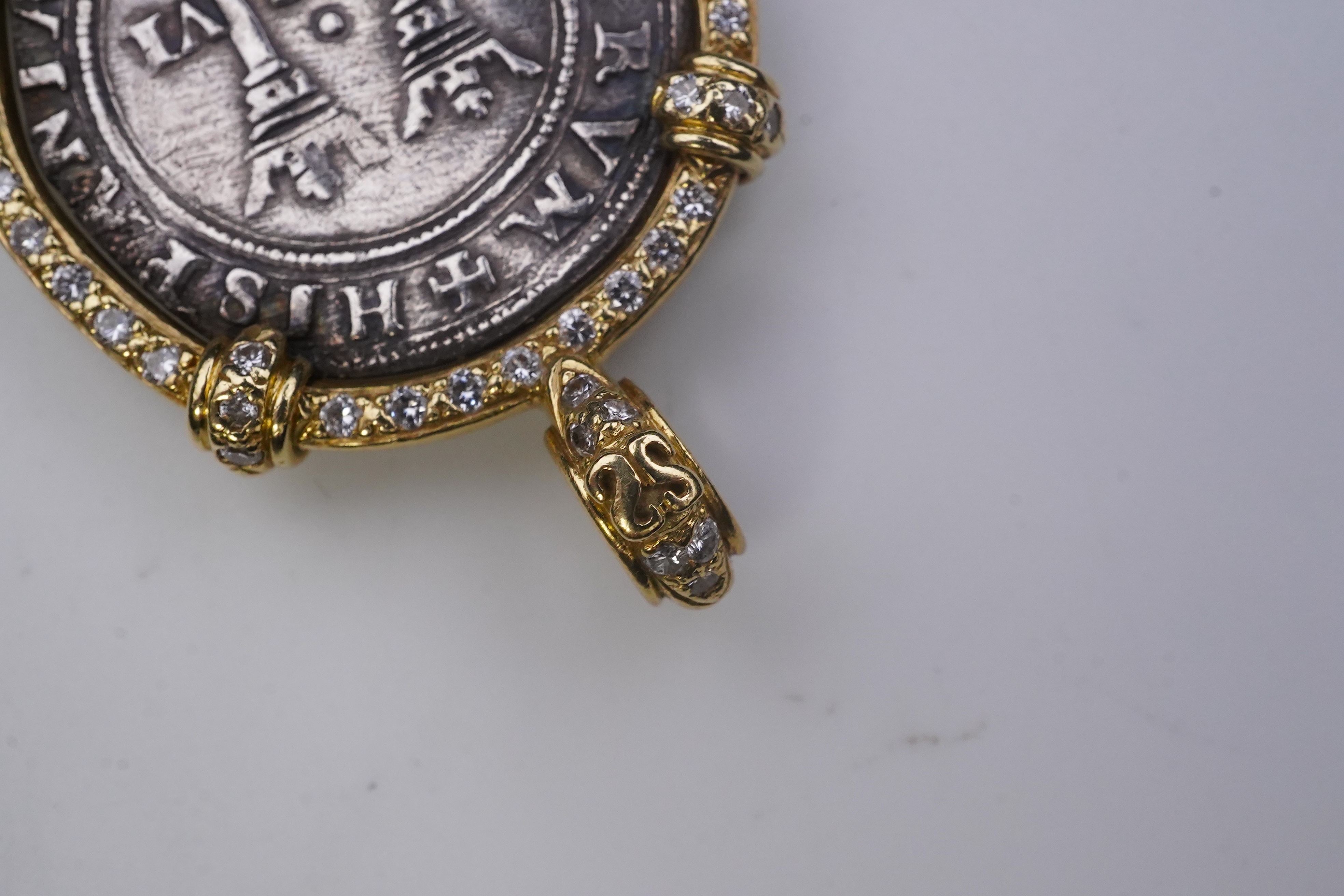 An unusual diamond and 16th century Mexican coin pendant